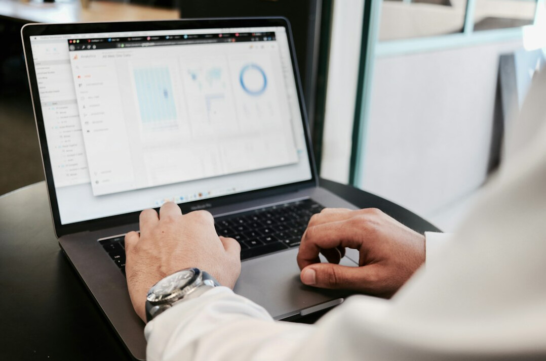 person calculating investments on laptop