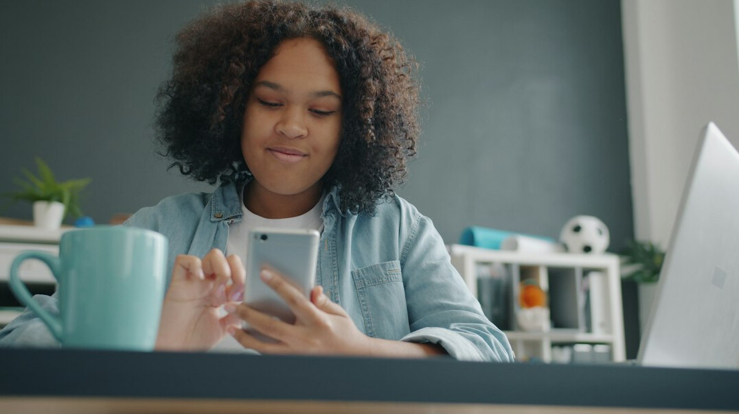 woman checking budget on phone