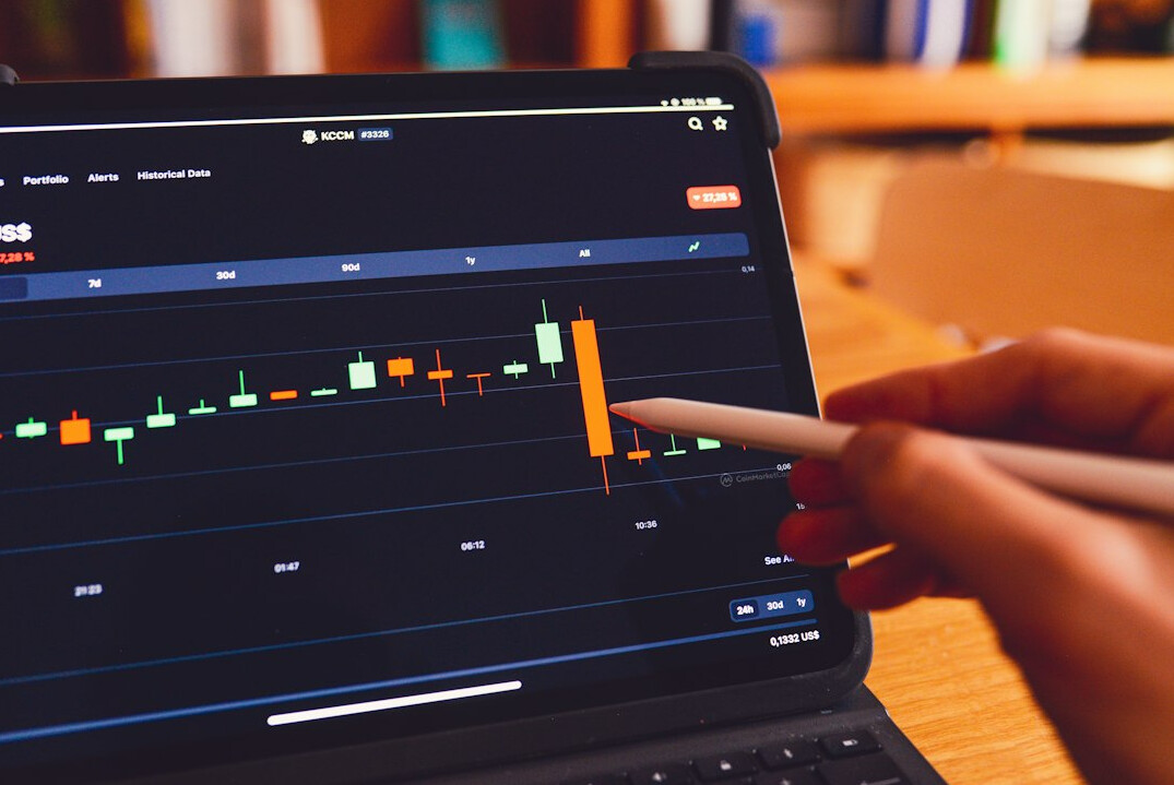 person analyzing stock charts